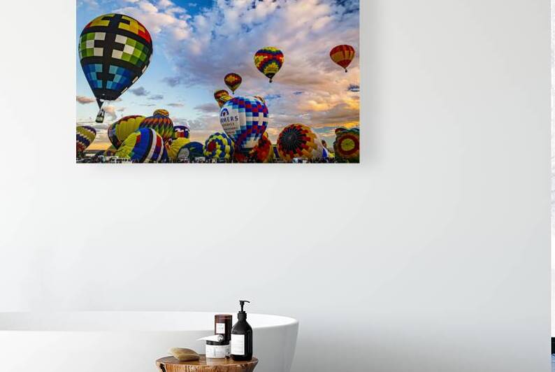 Vibrant hot air balloons filling the sky during a festival at sunrise by Gestalt Imagery