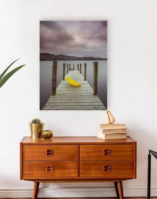 Umbrella on jetty at lake by Assaf Frank