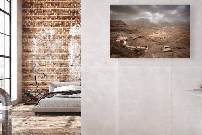 Souvenir stalls dot the rocky landscape of petra jordan under  by Gualtiero Boffi