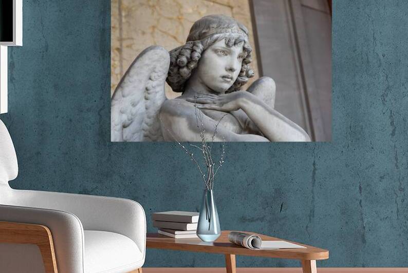 Cemetery statue of sad angel expressing solitude by Paolo Modena