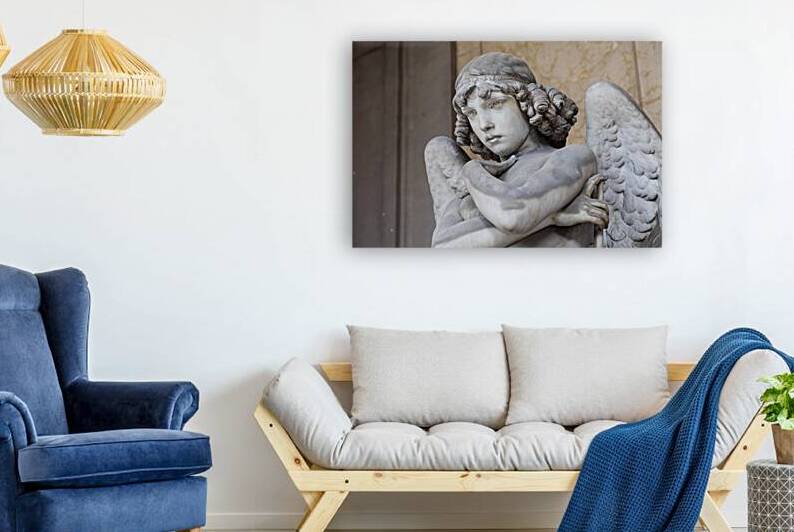 Cemetery statue of sad angel expressing solitude by Paolo Modena