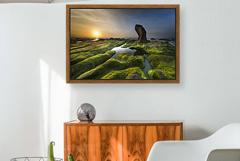 Aerial photography of green and brown rock formation near body of water at golden hour by Shamudy