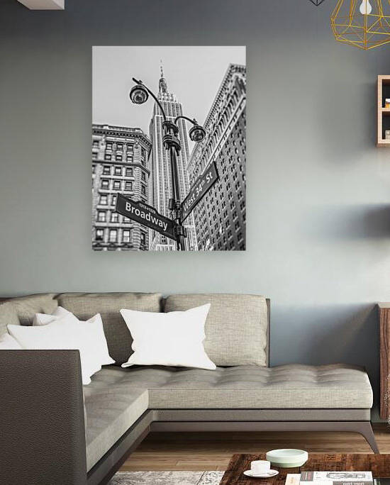 Street lamp and street signs with Empire State building in background - New York by Assaf Frank