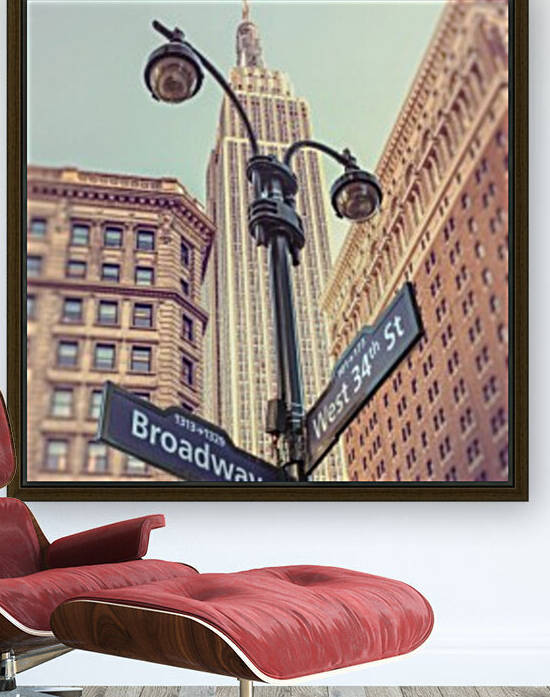 Street lamp and street signs with Empire State building in background - New York by Assaf Frank