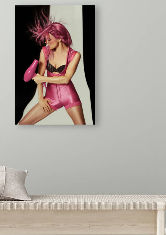 Portrait of a young woman in a pink one-piece jumpsuit  with a hair dryer her raspberry colored hair flying around by Artmood Visualz