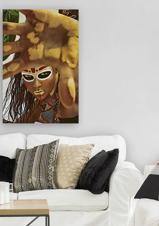 Portrait of a young woman with a tribal look makeup and wet hair wearing a traditional bead necklace her yellow painted hand in front of the camera by Artmood Visualz