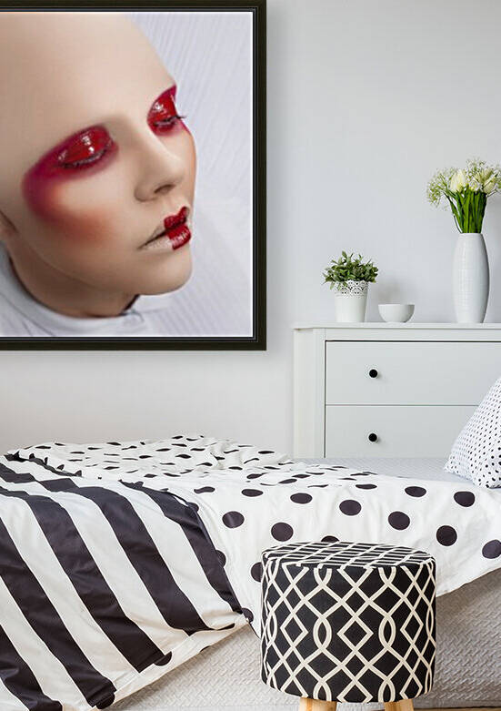 Close up of a bald woman wearing a white dress with large shoulder pads and glossy red makeup eyes closed in a white space by Artmood Visualz