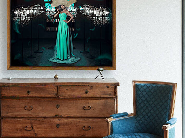 Beautiful and elegant woman wearing a turquoise gown with a big blonde wig her head in a round cage surrounded with lights and flying feathers in a dark room by Artmood Visualz