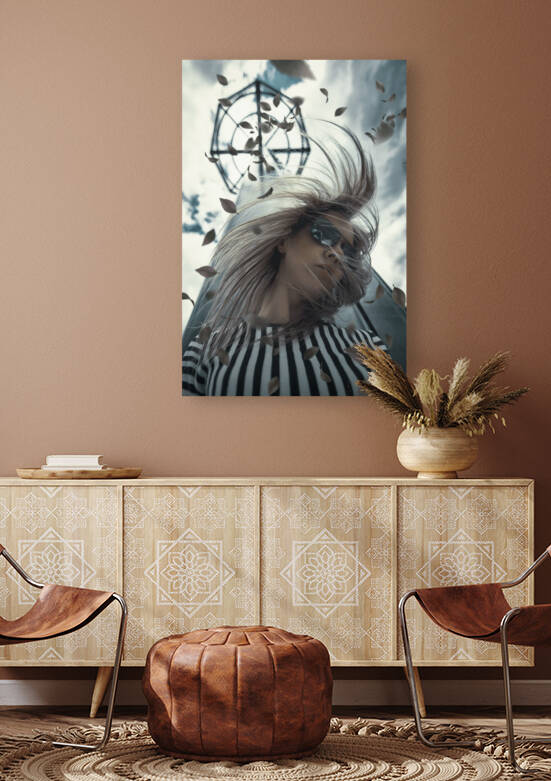 Young blonde woman wearing aviator style sunglasses and a black and white striped shirt her hair swirling in the wind in front of a tower with autumn leaves flying around by Artmood Visualz