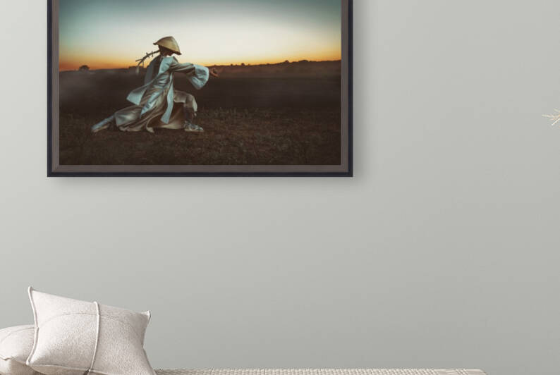 Blonde Asian woman with a long braid doing martial arts in a field in front of a sunrise while holding a wooden egg by Artmood Visualz