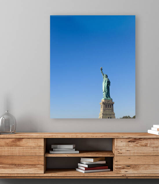 Statue of Liberty with bright blue sky by Jacobo Gutierrez