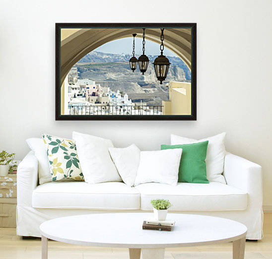 Lights hang from an arched ceiling with a view of a church, whitewashed buildings and landscape; Fira, Santorini, Greece by PacificStock