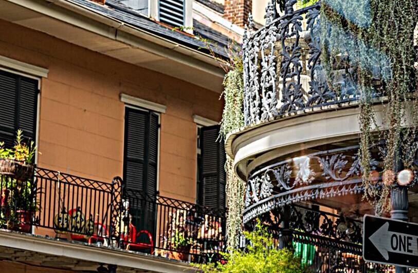 Traditional wrought iron balcony on brick New Orleans house by Steve Heap