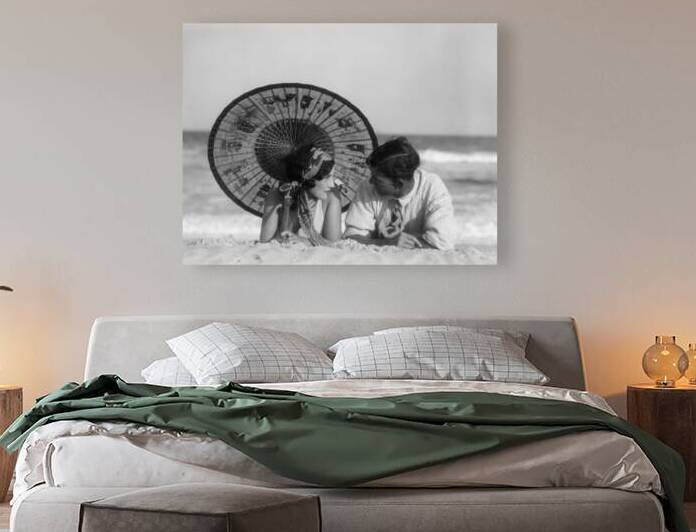 1920s COUPLE LAYING UNDER ORIENTAL PARASOL BEACH 195601 by Panoramic Images