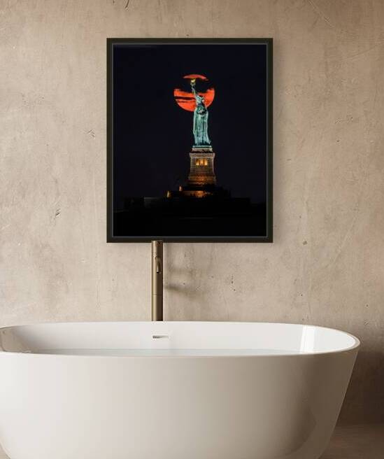 Sturgeon Moon Rising behind Lady Liberty by Geoffrey Prior