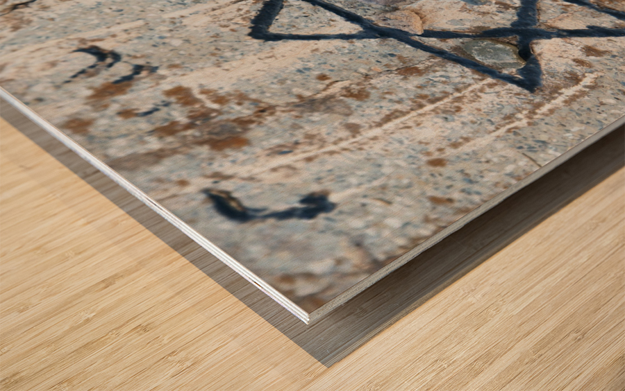 A star of david etched and painted on a rock with stones laying on it Wood print