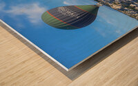 hot air balloons fly over the town Wood print
