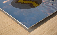 hot air balloon flies near the tourists . Wood print