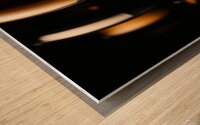 Dark wine glasses in an orange light close up view Wood print
